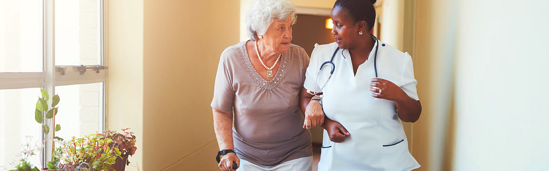 caregiver assisting an elderly woman